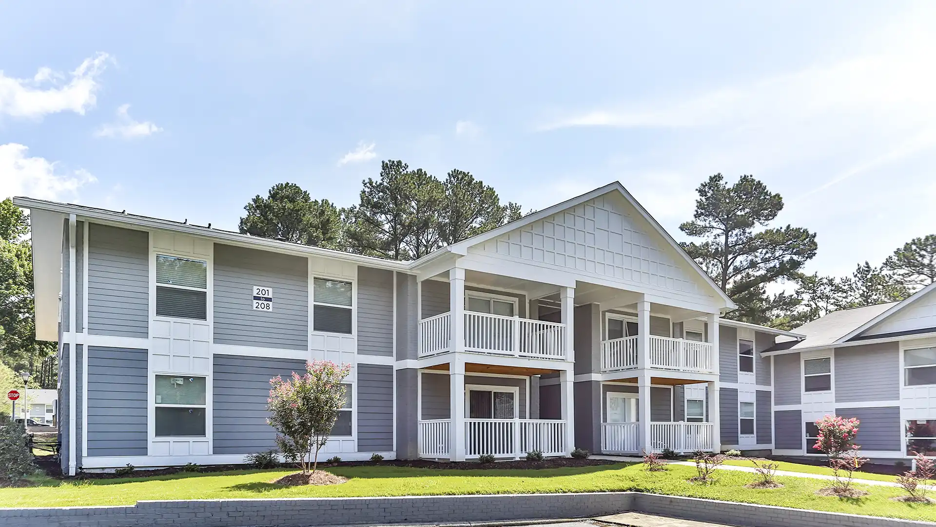 exterior view of two-story apartment building and surrounding landscape