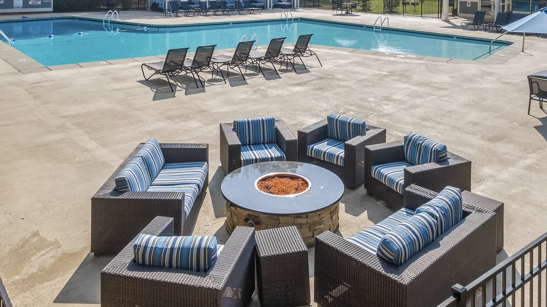 poolside fire pit with large cushy seating