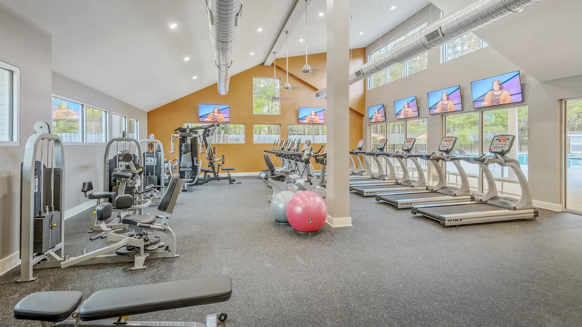 modern fitness center with free weights, cardio machines, strength stations and more