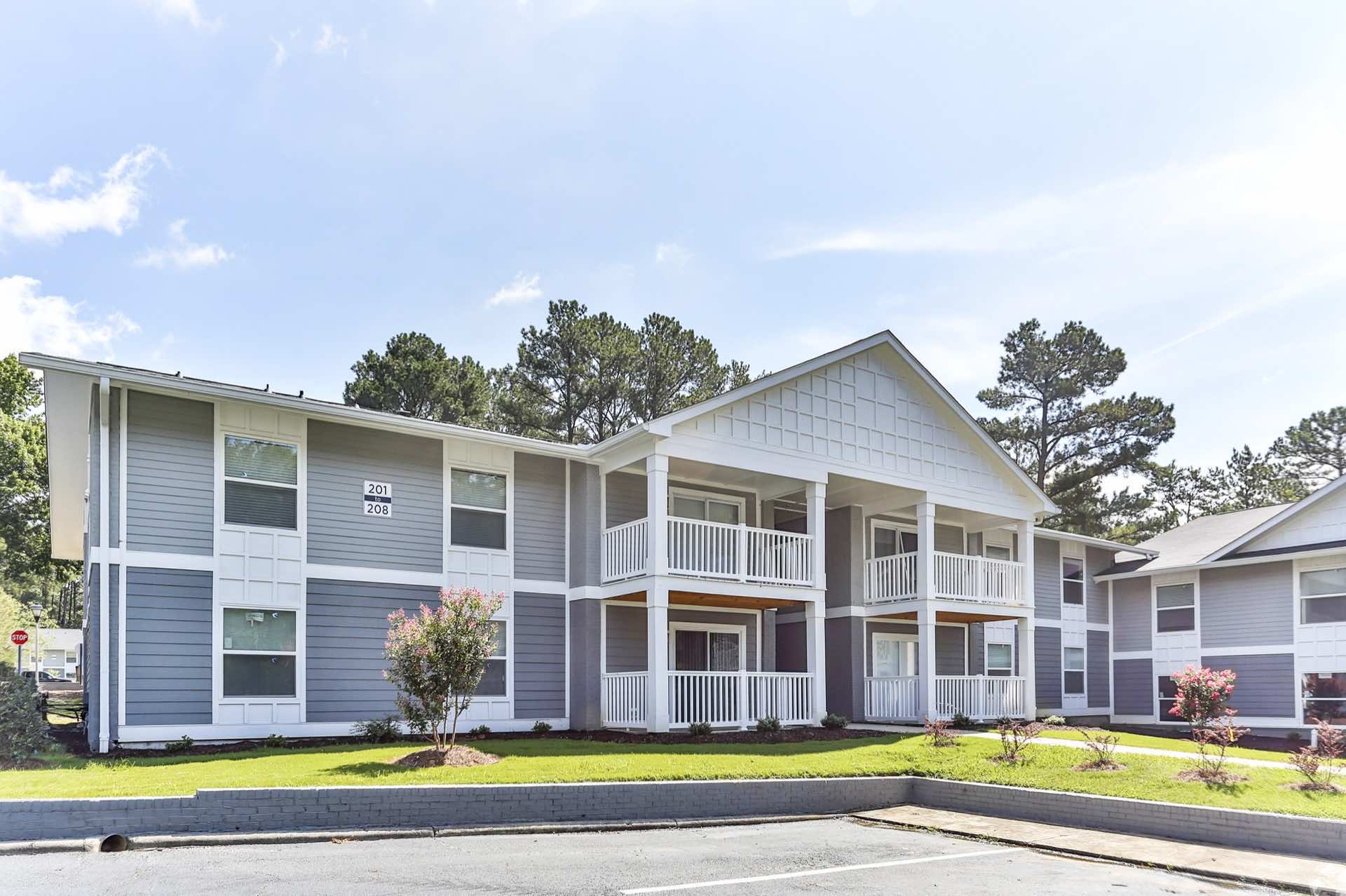 exterior view of two-story apartment building and surrounding landscape