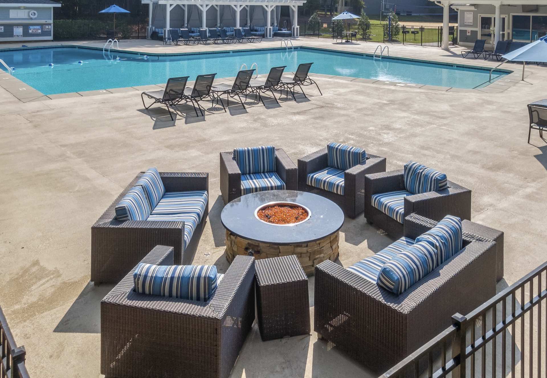 poolside fire pit with large cushy seating