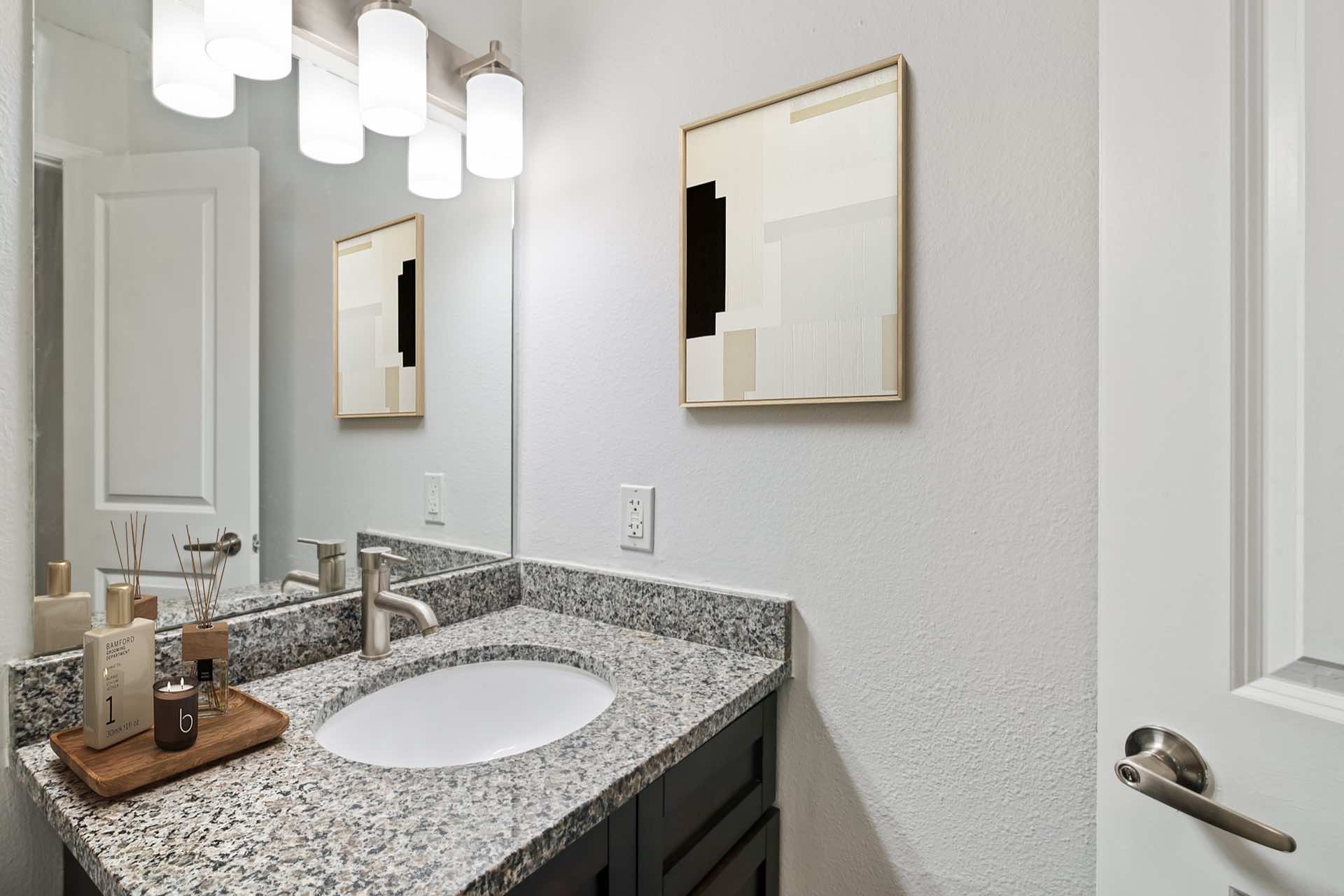 granite counters in bathroom and wall art