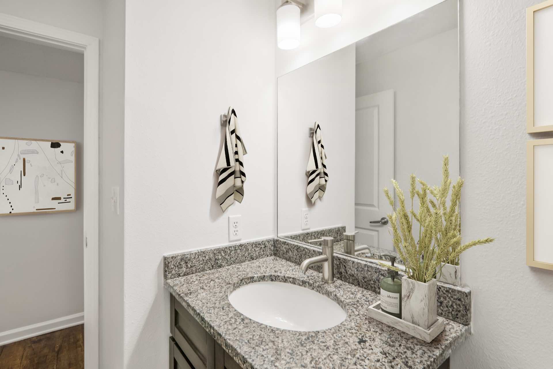 bathroom with granite counter and modern lighting