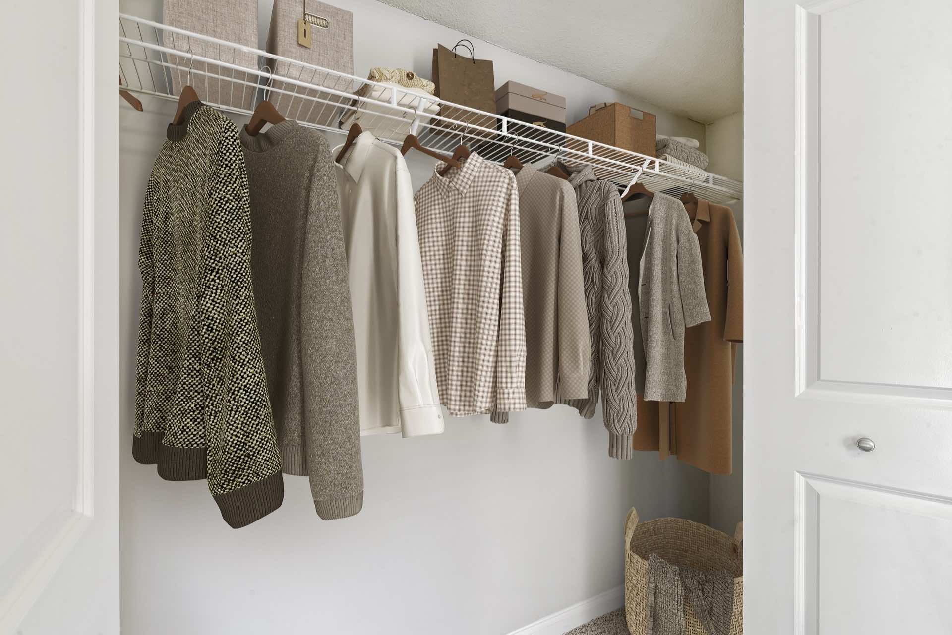 walk-in closet with white-wire shelving and clothes on hangers