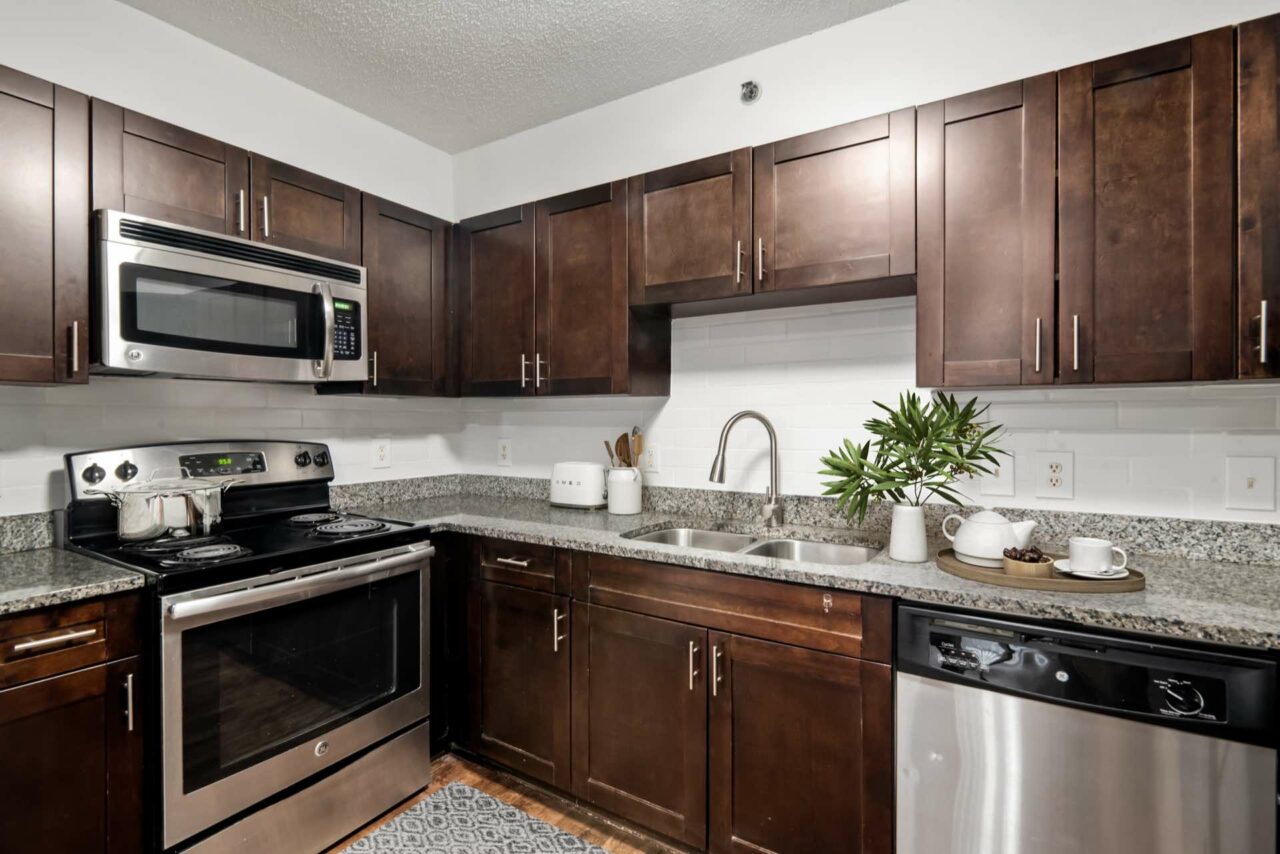 model kitchen with ample lighting and stainless appliances