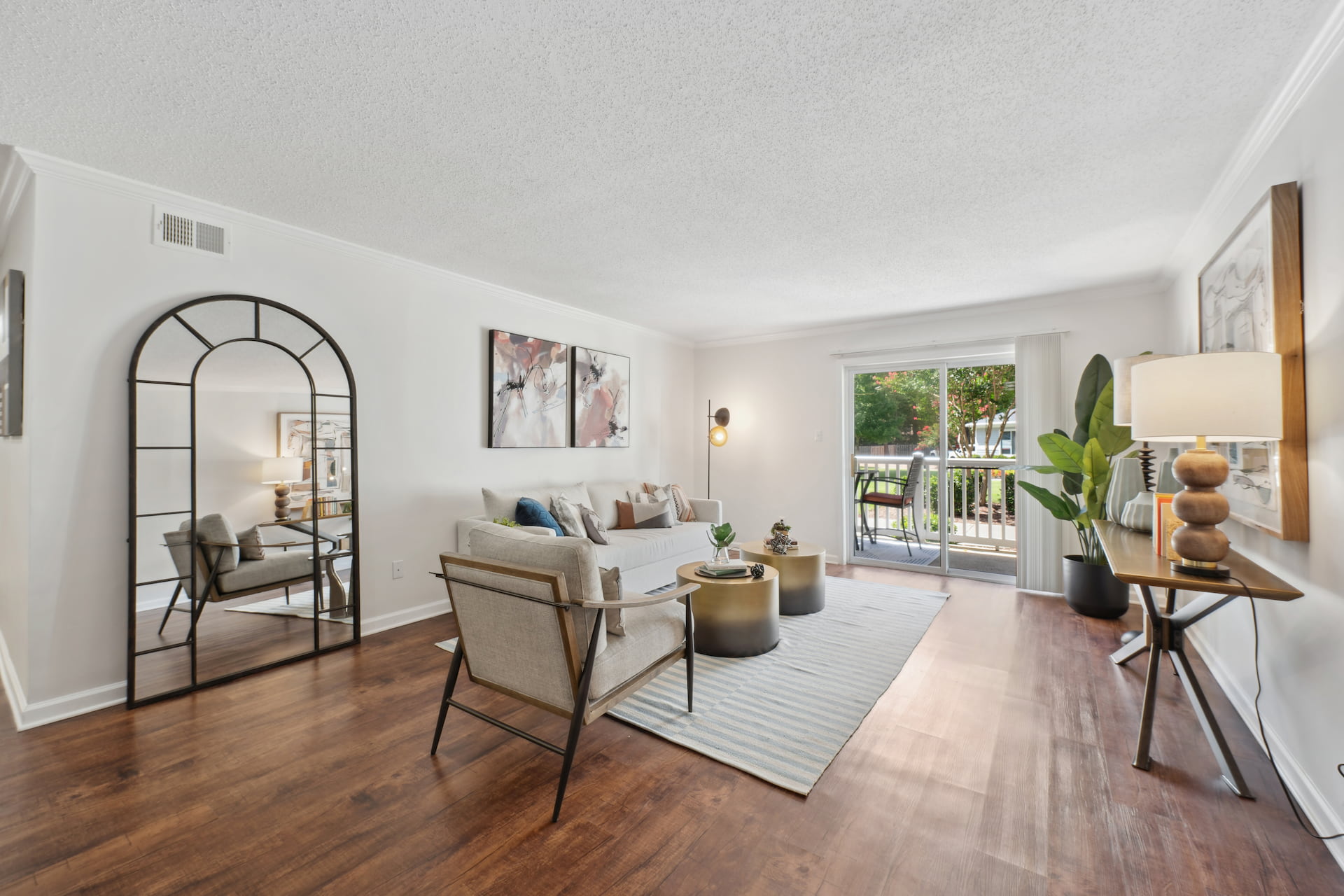 living room with wood-style flooring and large rug under couch