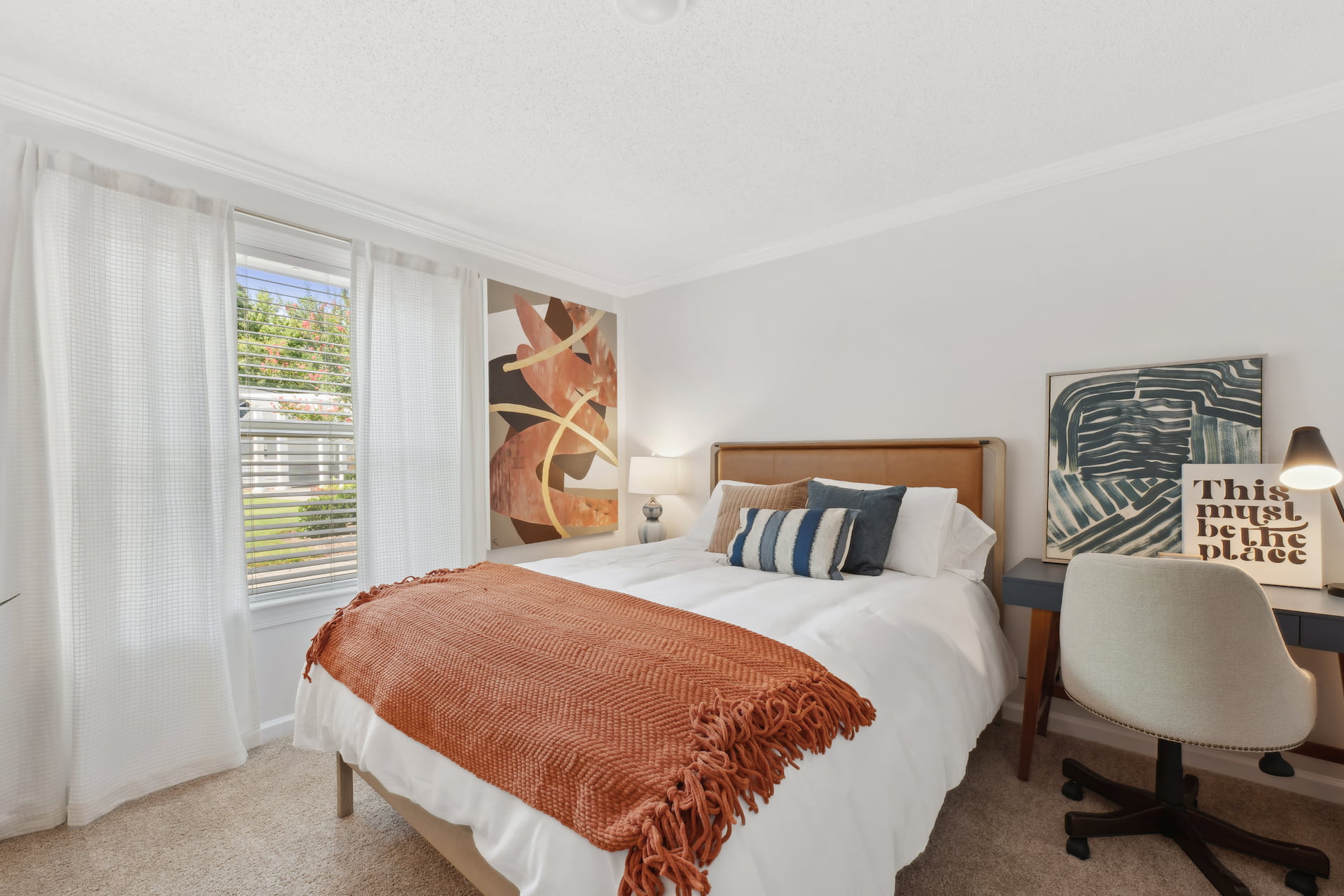 carpeted bedroom and desk with chair